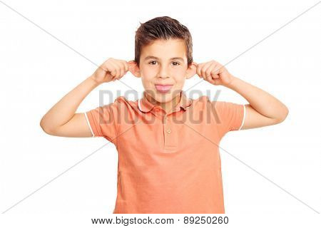 Silly boy in an orange shirt making a grimace and sticking his tongue out isolated on white background