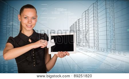 Young woman holging tablet and card