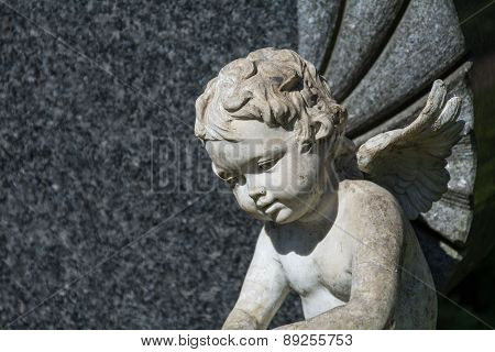 Putto Or Child Angel Statue As A Grave Stone On A Cemetery