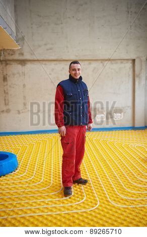 group of workera installing underfloor heating and colling in modern home