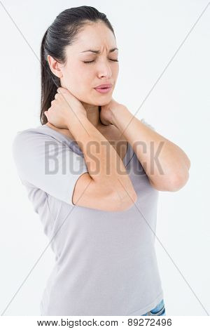 Brunette suffering from neck pain on white ackground