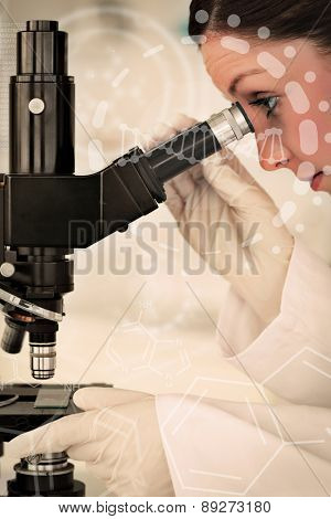 Science and medical graphic against good looking redhaired scientist looking through a microscope