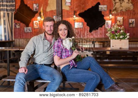 man and woman sitting on a bench in saloon
