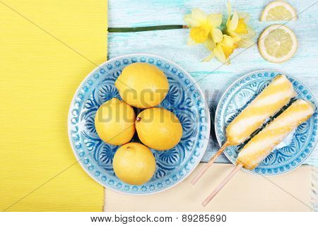 Lemons and ice cream on plates on table top view