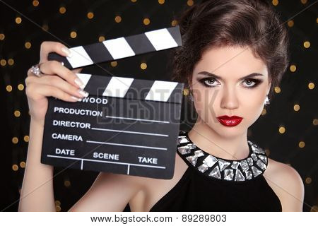 Beautiful Brunette Woman Model Holding Film Clap Board Cinema. Fashion Portrait Of Girl With Makeup,
