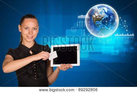 Smiling woman holging tablet and card