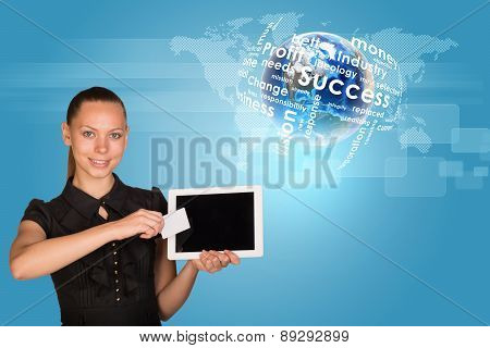 Businesswoman holging tablet and card