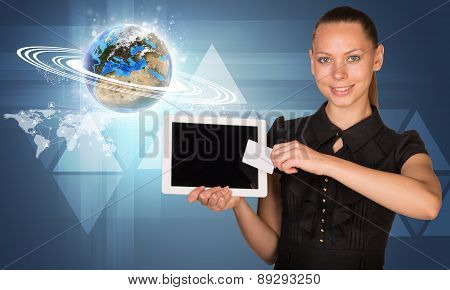 Businesswoman with glowing Earth model