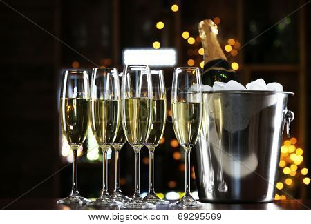 Glasses of champagne on bar background