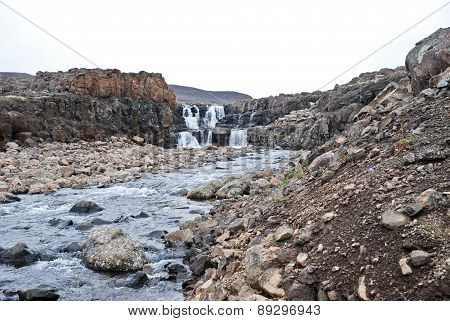 Landscape With Rocks And A Waterfall.