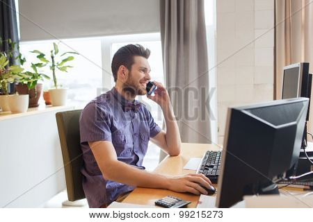 business, startup and people concept - happy businessman or creative male office worker with computer calling on smarphone