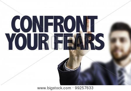 Business man pointing the text: Confront Your Fears