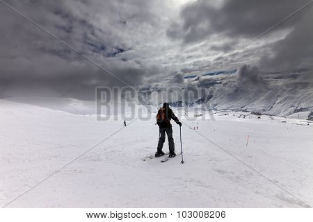 Skiers On Ski Slope Before Storm