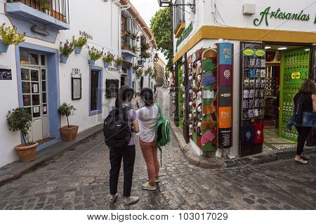 Two Young Girls Take Photo In The Romero Street, Jewish Quarter In Cordoba, Province Cordoba, Andalu