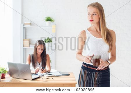 Portait of beautiful successful business woman holding cup coffee