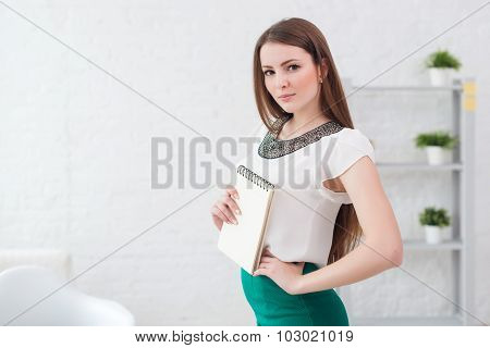 Portait of beautiful successful business woman standing at office.