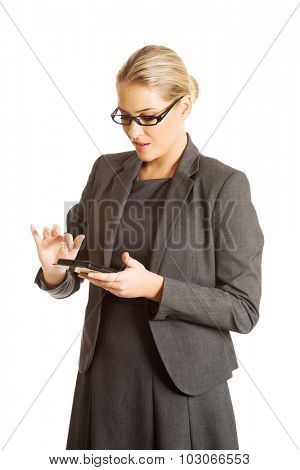Beautiful businesswoman sending a message