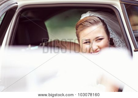 Portrait Of A Bride In The Car On Wedding Day