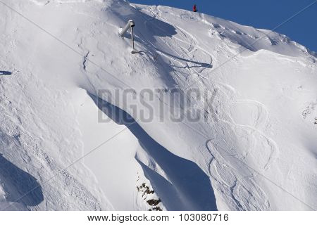 Tracks on a mountain Slope and Gas cannon for reclamation avalanches