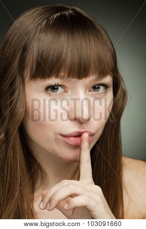 It's a Secret! beautiful girl with his finger to his mouth