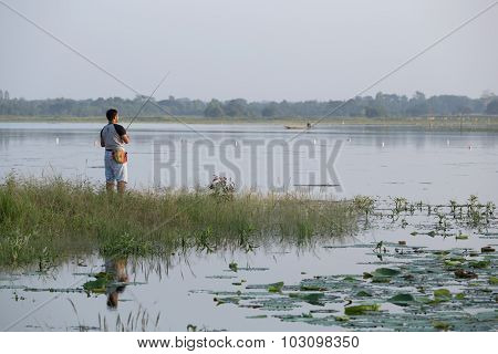 Unidentified Man Fishing In Huayyang Reservoir