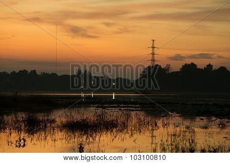 Silhouette Of High Voltage Post With Huayyang Reservoir