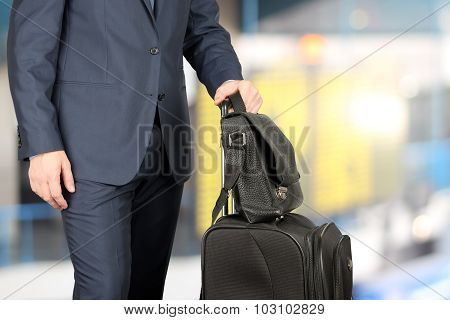 Young Businessman  In  A Modern  Stylish Suit With  Luggage In  The Airport
