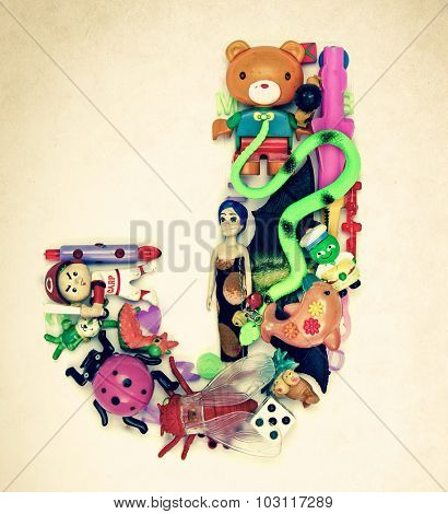 the letter    J  made from small toys