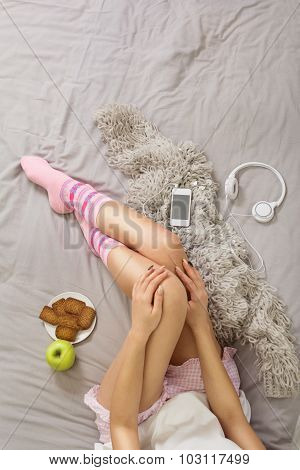 Woman in cozy clothes in bed relaxing