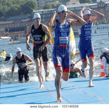 Male Swimmers Climbing Up From The Water