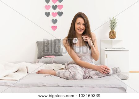 Beautiful young woman in bed in morning