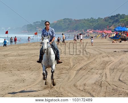 Young Woman Riding A Horse On Legian Beach