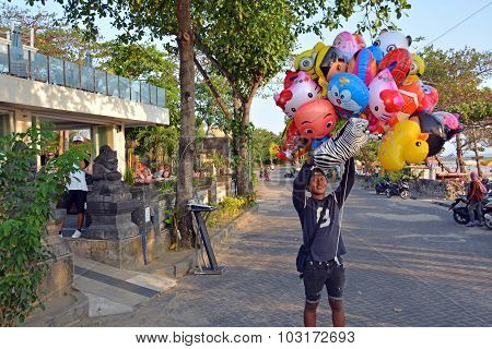 Young Vendor Of Animal Shaped Balloons At Legian Beach