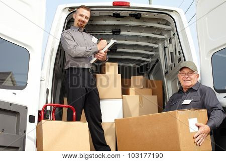 Group of delivery men with parcels near shipping truck. Parcel service.