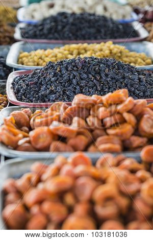 Dry Fruits And Spices Like Cashews, Raisins, Cloves, Anise, Etc. On Display For Sale In A Bazaar In