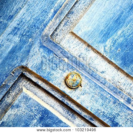 Stripped Paint In The Blue Wood Door And Rusty Nail