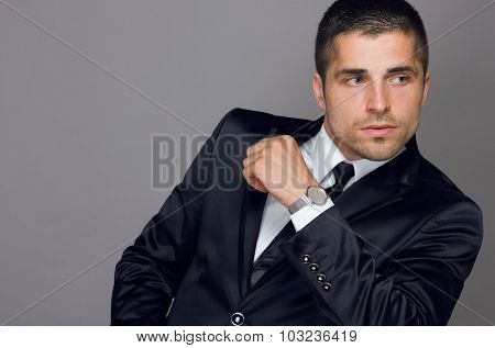 handsome young man wears a watch