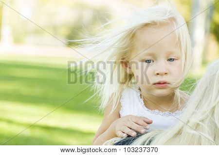 Meloncholy Portrait of Cute Little Girl Outside in Park.