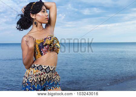 Young beuatiful African American girl relaxing at the beach.
