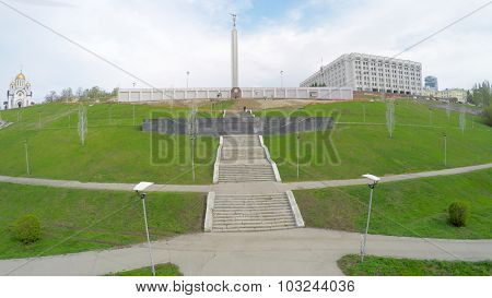 SAMARA - MAY 05, 2015: Staircase on grass hill with Glory Monument and church of St. George on top at spring day. Aerial view video frame
