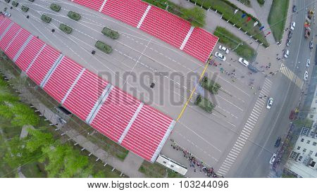 SAMARA - MAY 06, 2015: Armoured vehicles ride along street with crowd of people at spring evening. Aerial view video frame