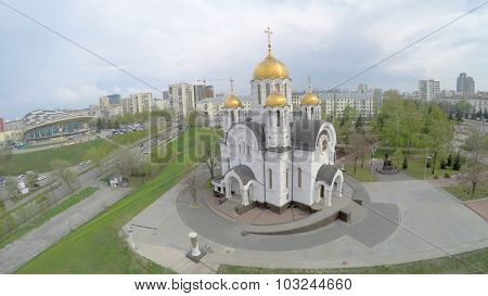 SAMARA - MAY 05, 2015: Cathedral of St. George near residential houses at spring cloudy day. Aerial view video frame