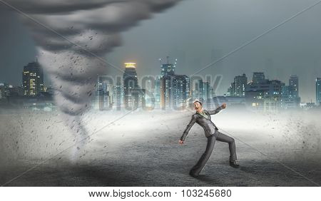 Businesswoman running from the tornado