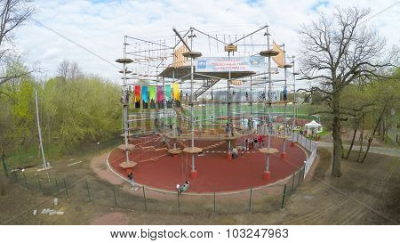 MOSCOW - MAY 04, 2015: Many young people get fun on Tall Rope Park Skytown in VDNH at spring cloudy day. Aerial view video frame