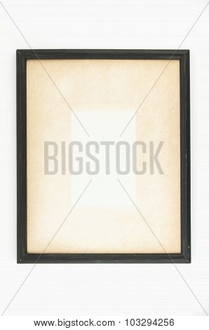 Old paper in black wooden picture frame.