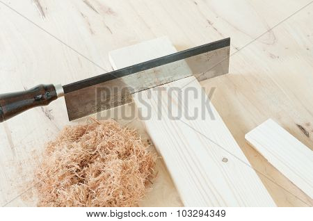 Cutting piece of wood.