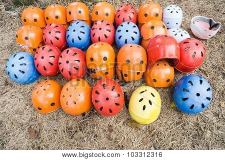 A Bunch Of Outdoor Adventure Safety Helmet On The Ground.