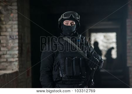 Fully equipped military men with automatic weapons playing airsoft strikeball