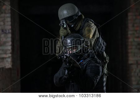 Fully equipped military men with automatic weapons playing airsoft strikeball