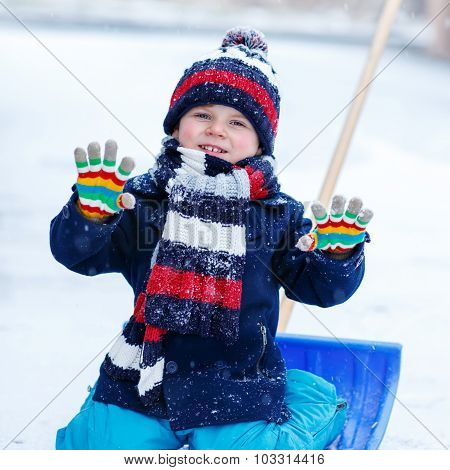 Cute Little Funny Boy In Colorful Winter Clothes Having Fun With